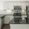 Well-lit kitchen with ample counter space and stainless steel appliances